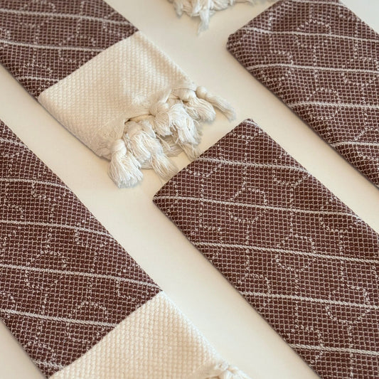 Flat lay image of folded WALNUT Turkish Hand Towels on a white background