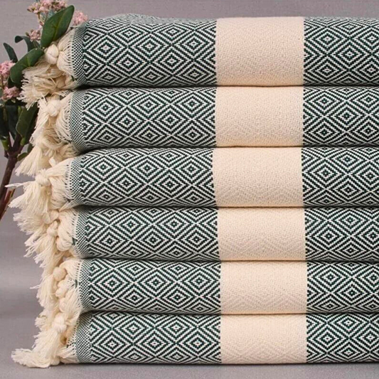 Folded PINE Turkish Kitchen Towels with dark green geometric patterns and cream-colored borders, stacked neatly