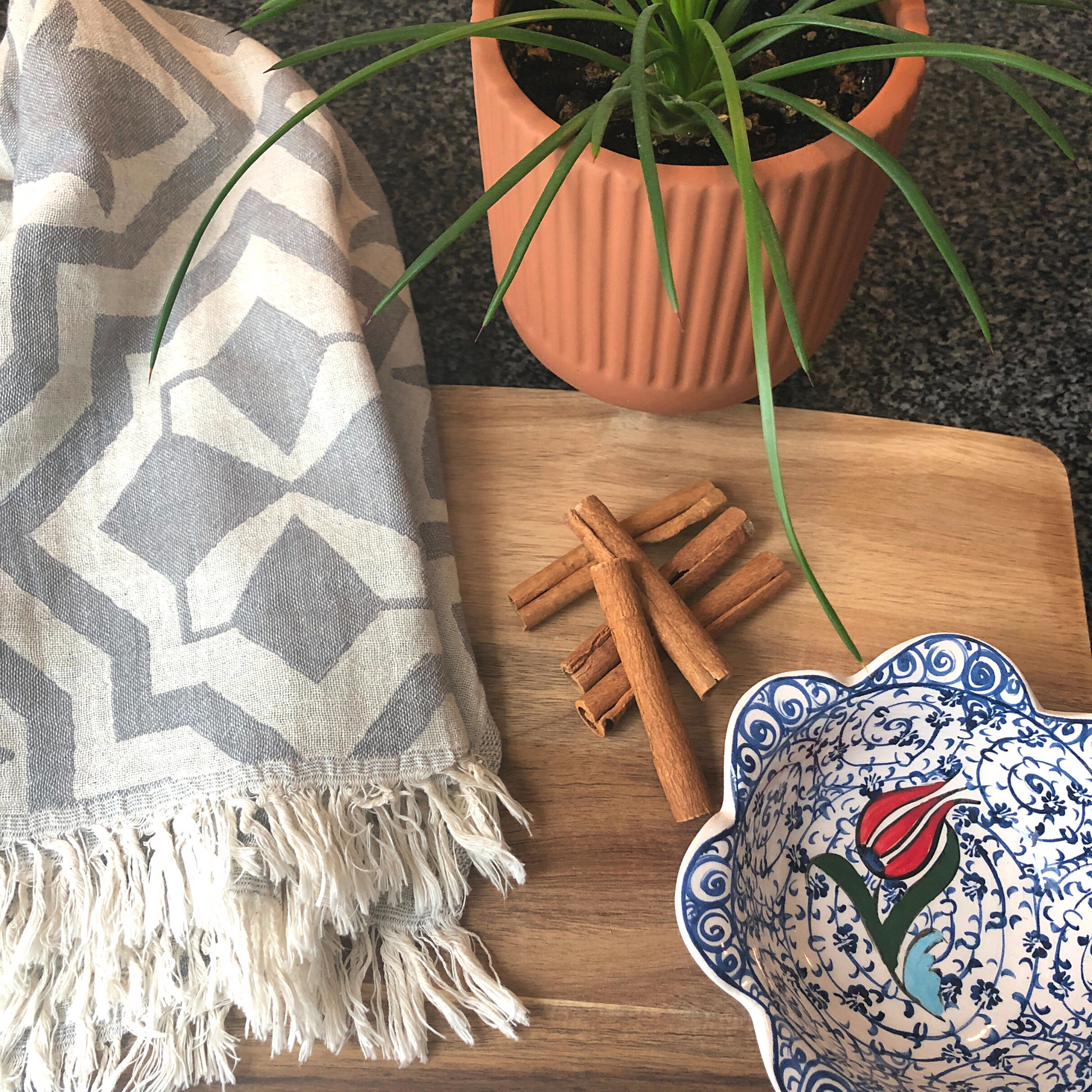 TULIP Turkish Kitchen Towel on kitchen countertop with cinnamon sticks, red-tulip snack bowl and plant