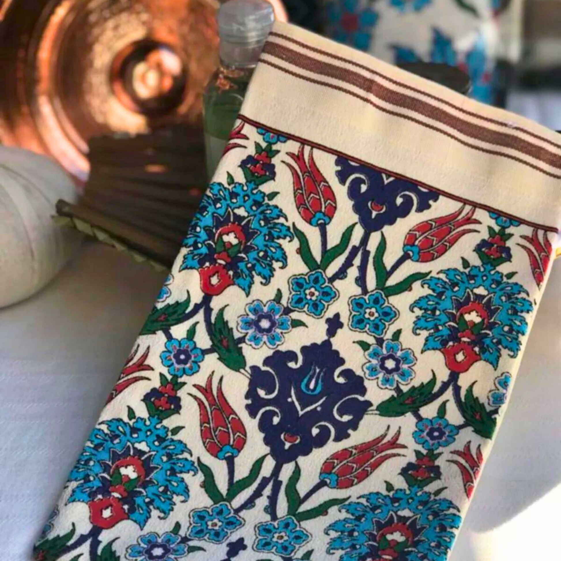 Turkish bath mitt with vibrant carnation pattern and brown stripes at the open end