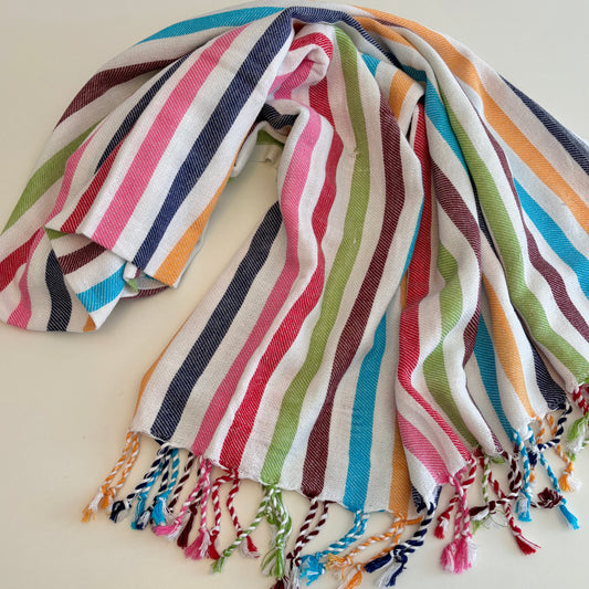 Multicoloured striped CONFETTI Turkish Towel with tassels on a light background