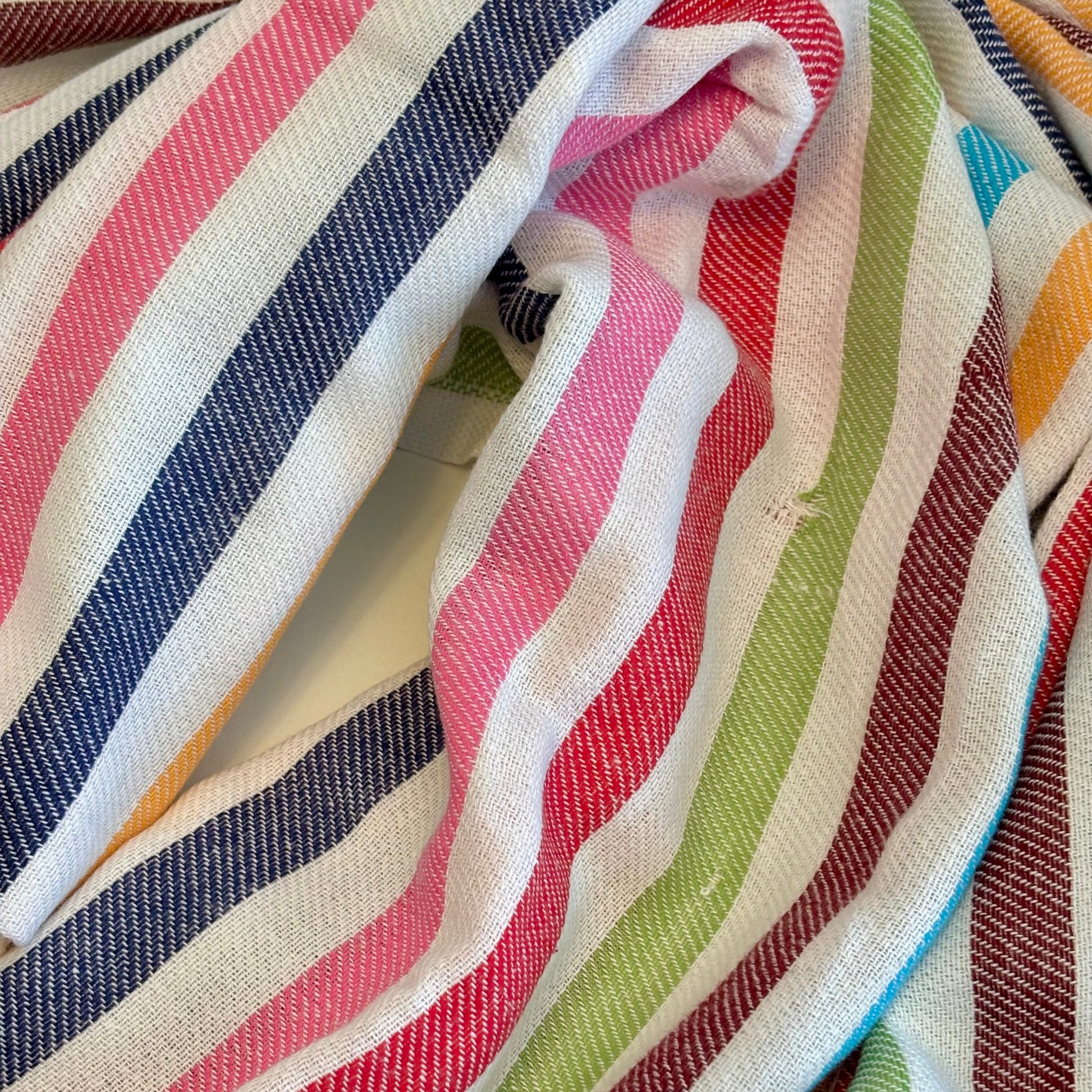 Close-up of colorful striped CONFETTI Turkish Towel with red, blue, green, and white stripes.