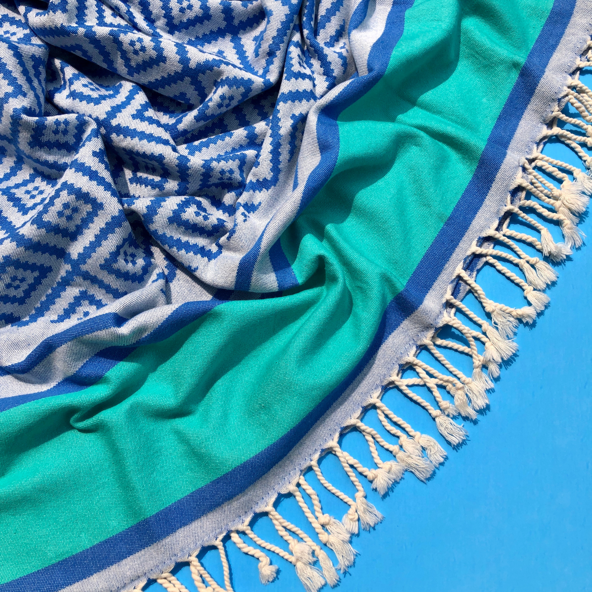 DIVAN Turkish bath & beach towel with cobalt blue pattern and a wide teal green stripe on one end