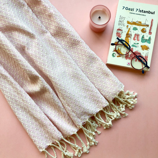 ISTANBUL Throw with Istanbul book, reading glasses and pink candle on pink background