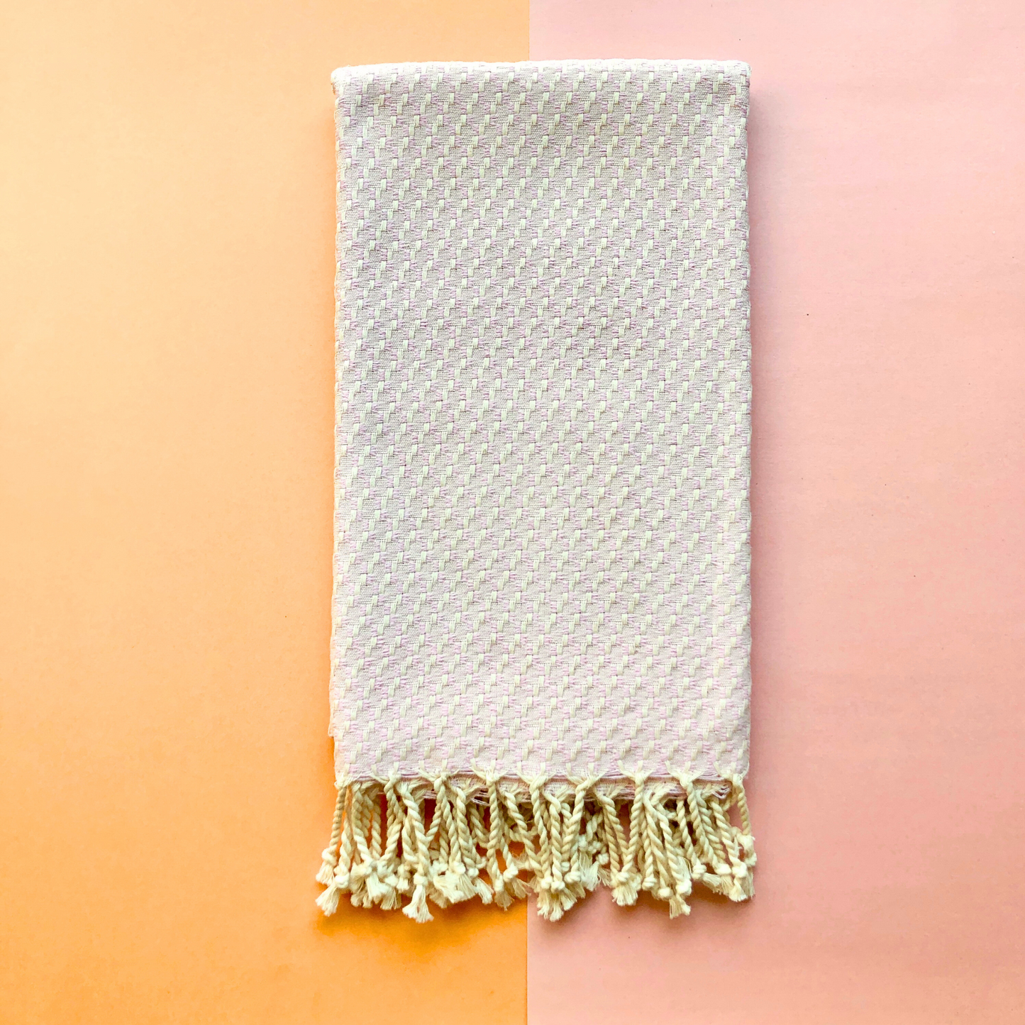 Folded ISTANBUL Throw on orange and pink background