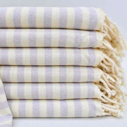 Stack of folded LAVENDER Turkish Towels with soft lavender colour stripes and natural colour hand-knotted fringes