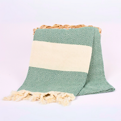 Basil green Turkish towel with diamond patterns, displayed in a basket