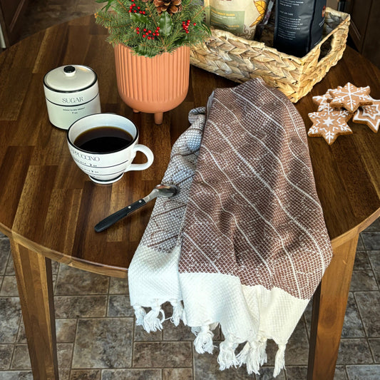 Cup of coffee with WALNUT Turkish Hand Towels on a wooden table, surrounded by Christmas decorative items