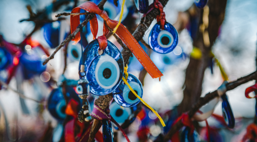 Turkish evil eye beads with colourful ribbons, hanging from trees