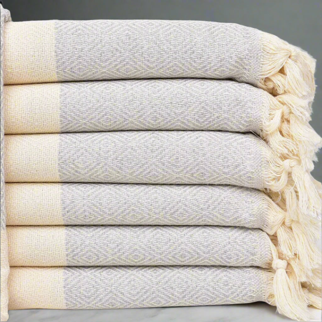 Stack of folded ISTANBUL Turkish Towels placed on marble surface