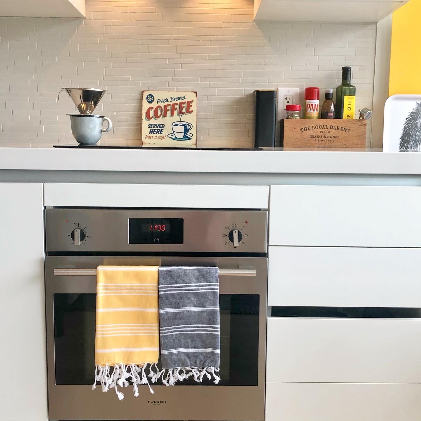 Yellow and black striped Turkish hand towels in fun modern kitchen