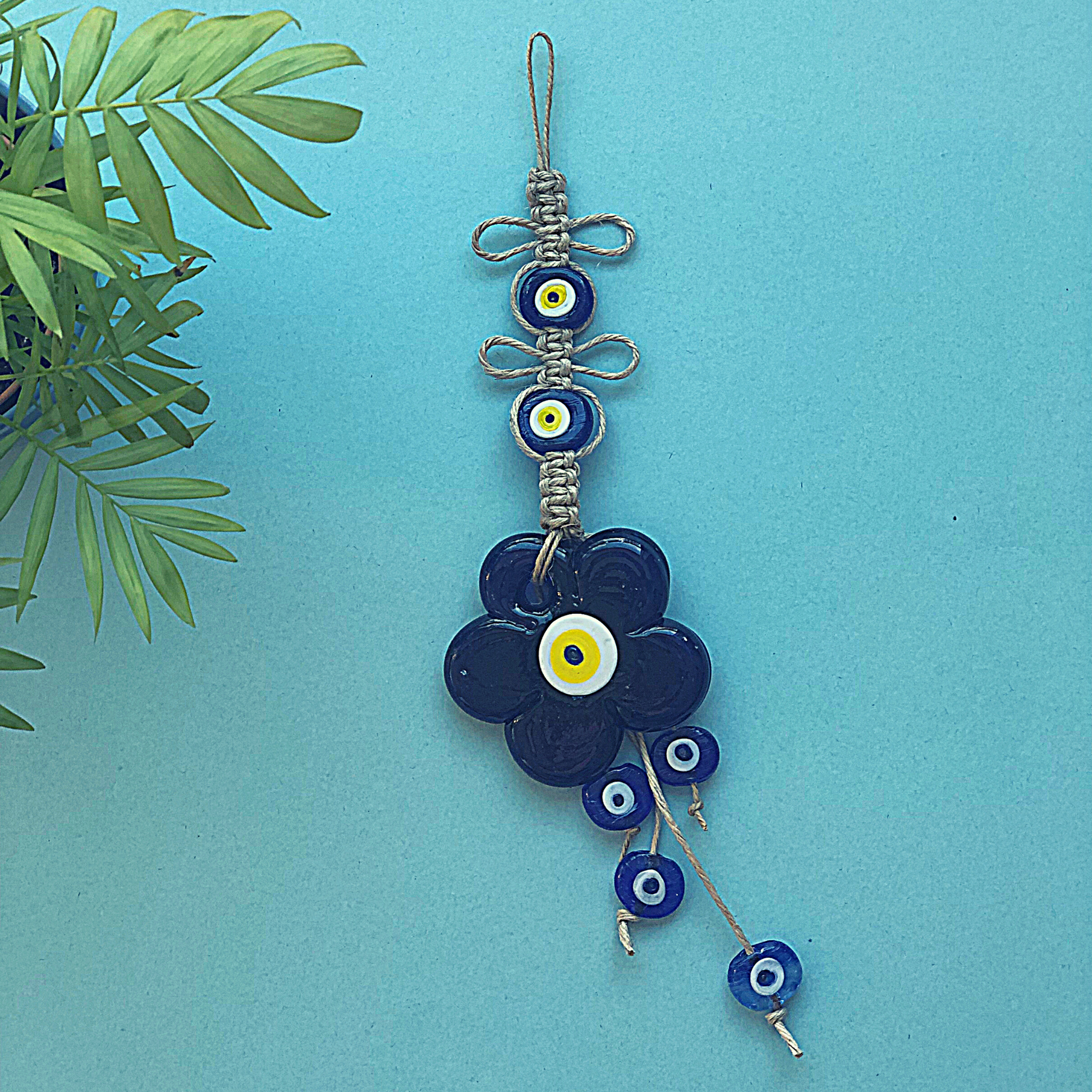 Evil eye macrame wall hanging with large glass evil eye disc and smaller nazar beads 