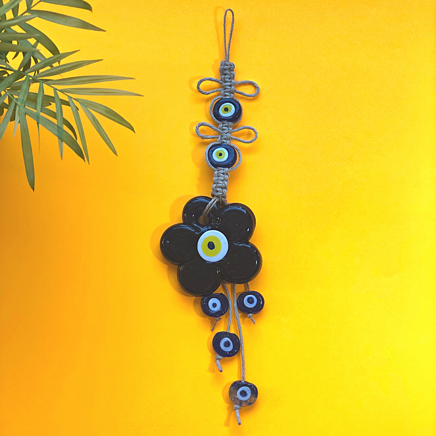 Nazar evil eye wall hanging with daisy shaped evil eye disc and small evil eye beads on macrame