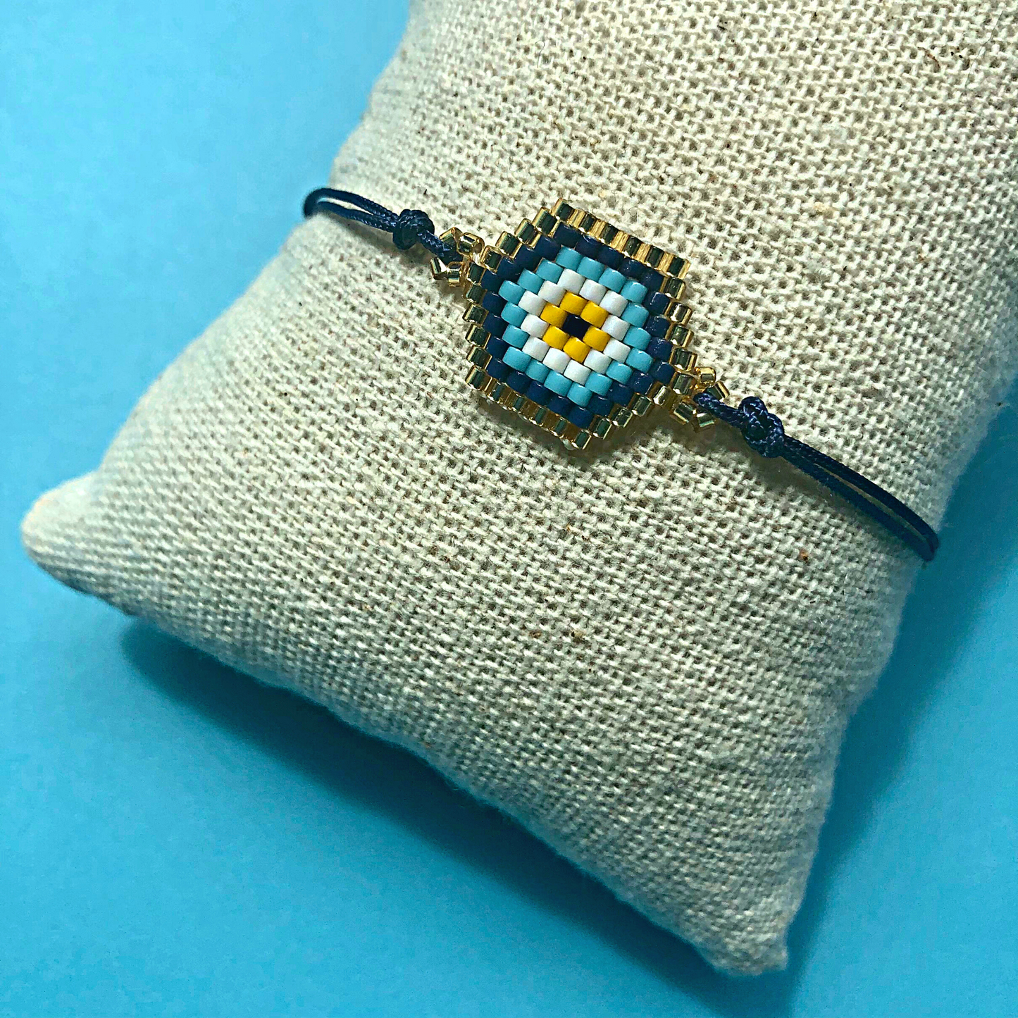 MARDIN EVIL EYE miyuki beads cord bracelet on jute display pillow