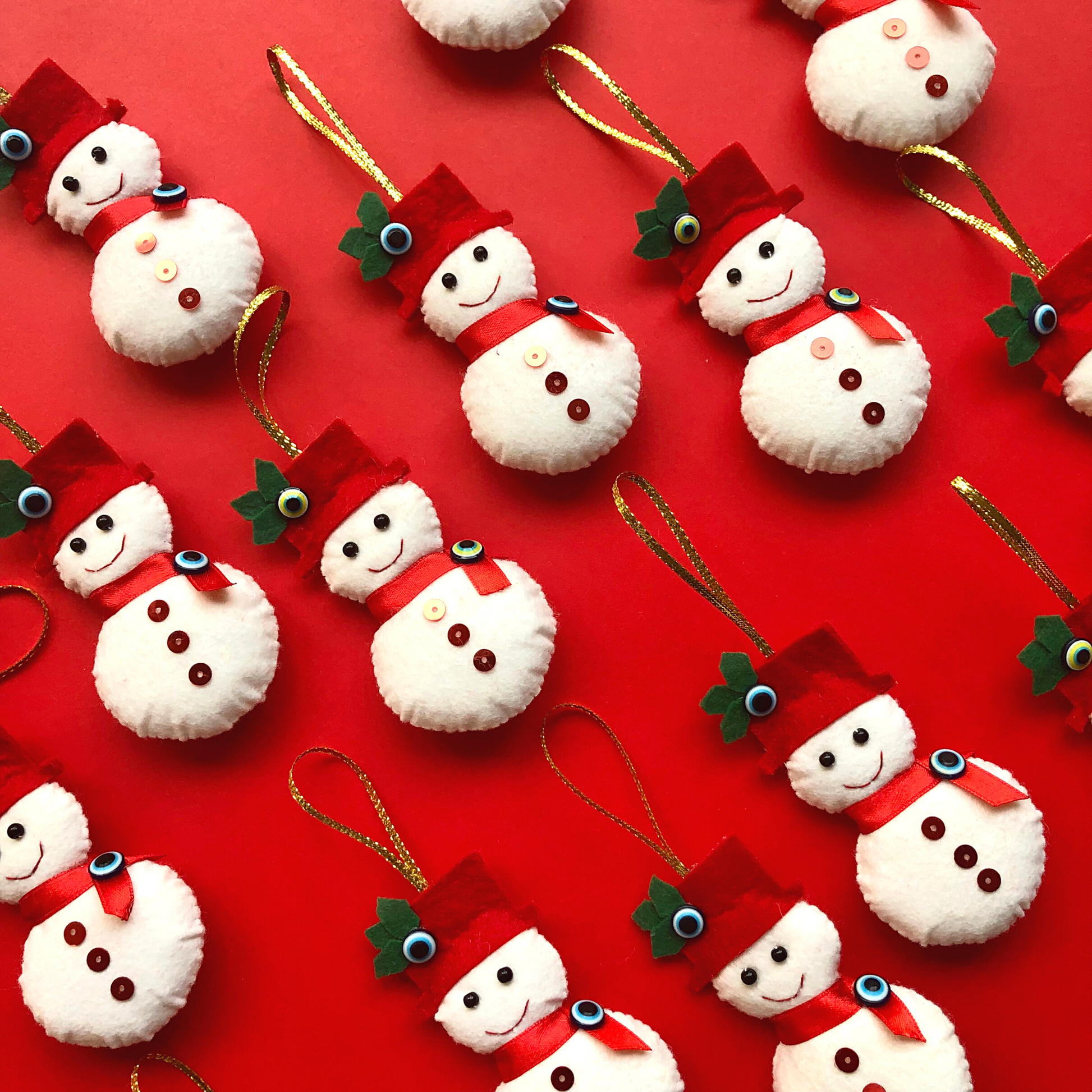 Snowman NAZAR Felt Christmas Ornaments with evil eye beads on red festive background