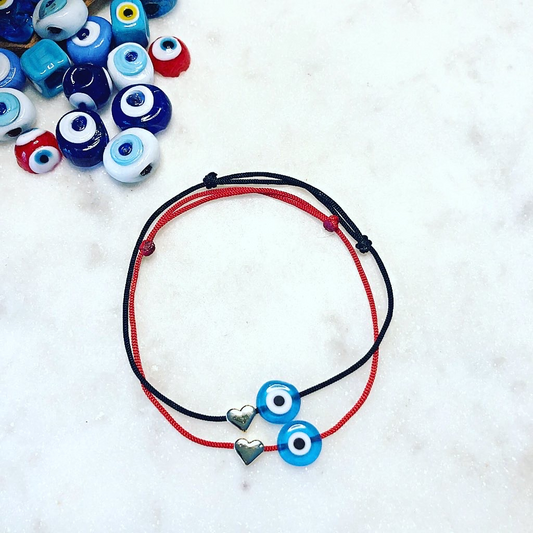 Stacked NAZAR HEART Evil Eye Cord Bracelets on black and red cords with heart-shaped metal charms