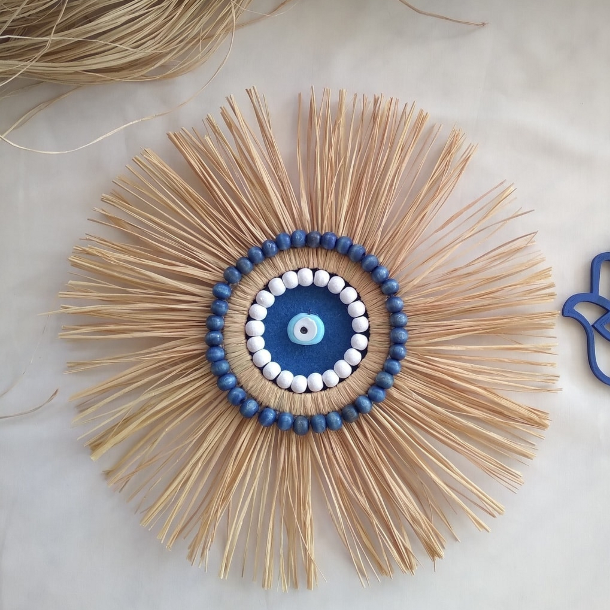 Round NAZAR Raffia Wall Decor with blue Turkish evil eye beads 