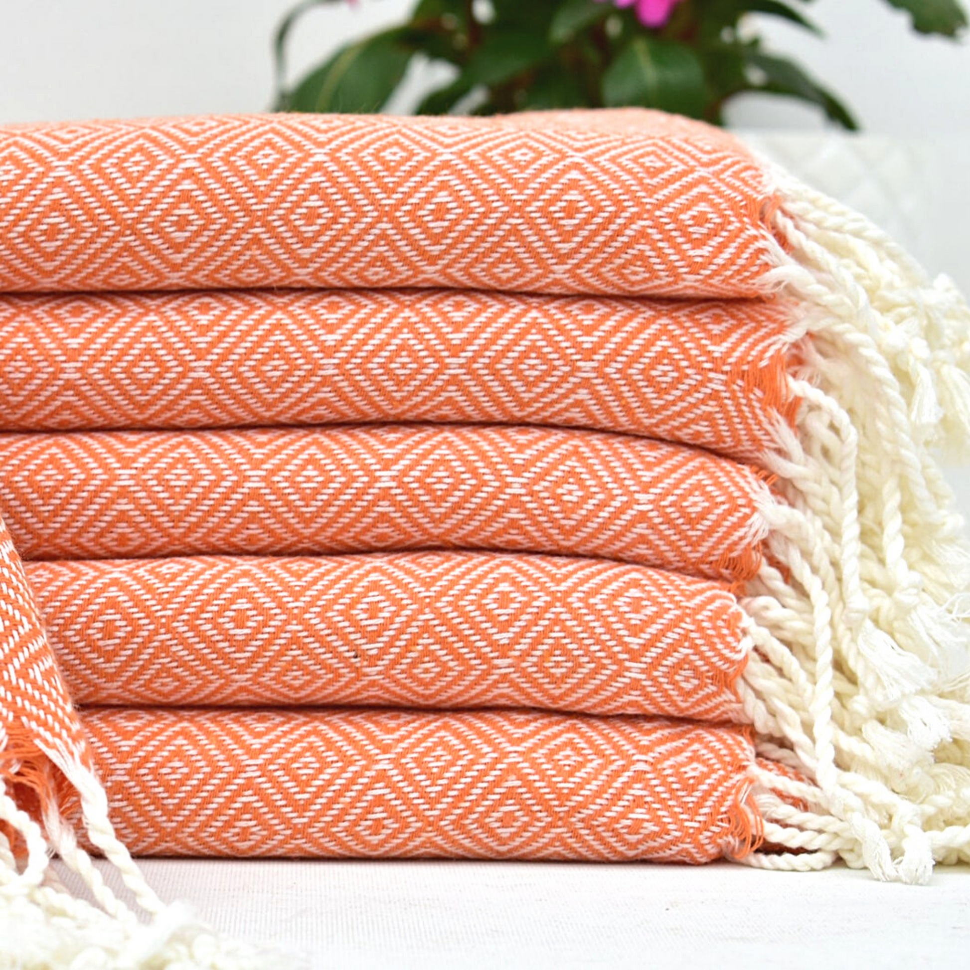 Stack of folded ORANGE SULTAN Turkish Towels 